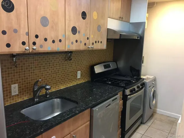 a kitchen with granite countertop cabinets and a stove