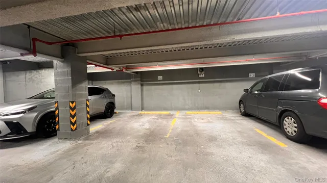 a view of parking garage with cars parked
