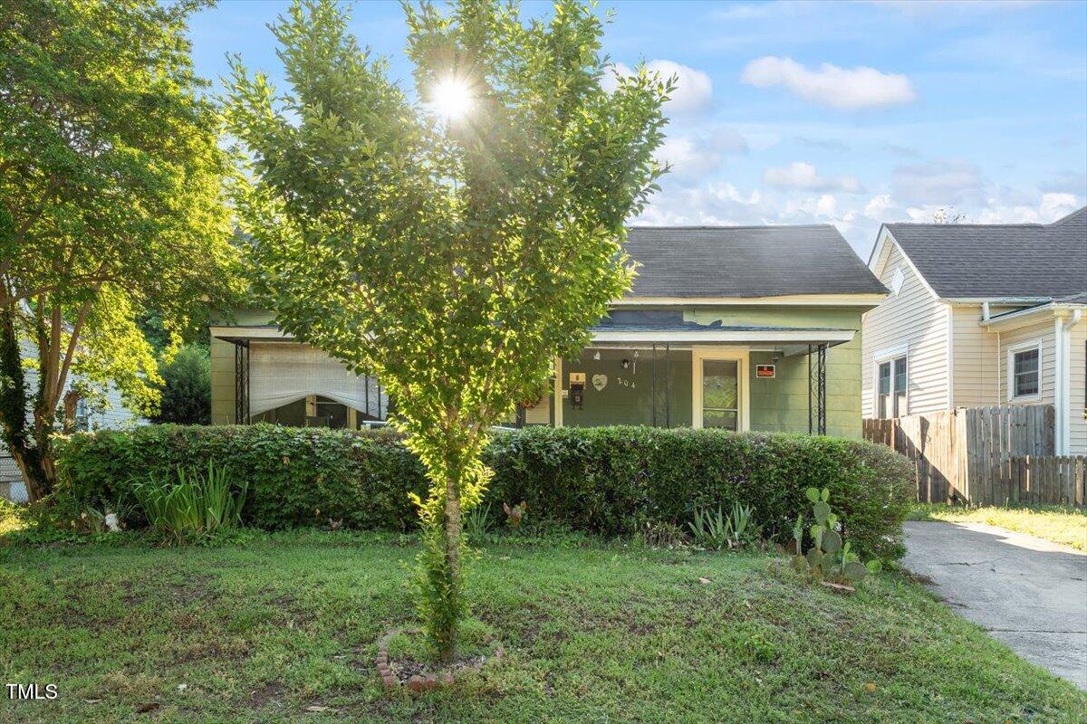 204 Heck Street Raleigh, NC 27601 - Photo 4 of 13 a front view of a house with a yard