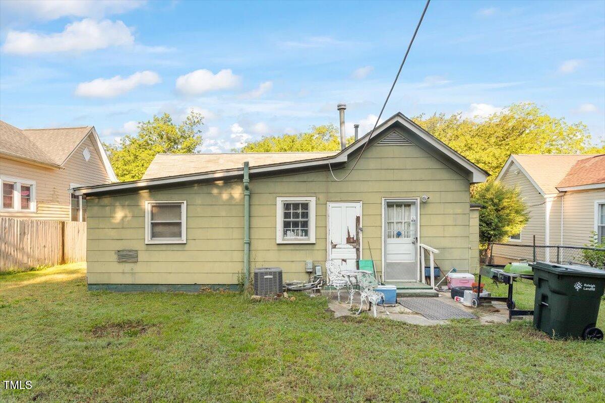 204 Heck Street Raleigh, NC 27601 - Photo 5 of 13 a view of backyard of house with wooden deck and seating
