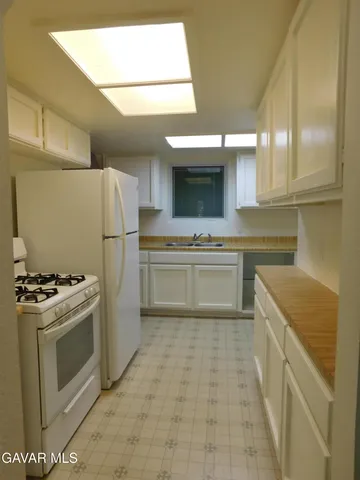 a kitchen with a stove sink and refrigerator
