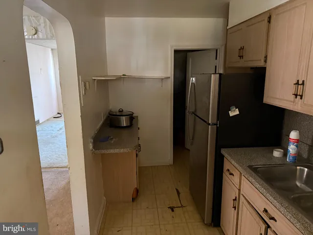 a kitchen with a refrigerator and a sink