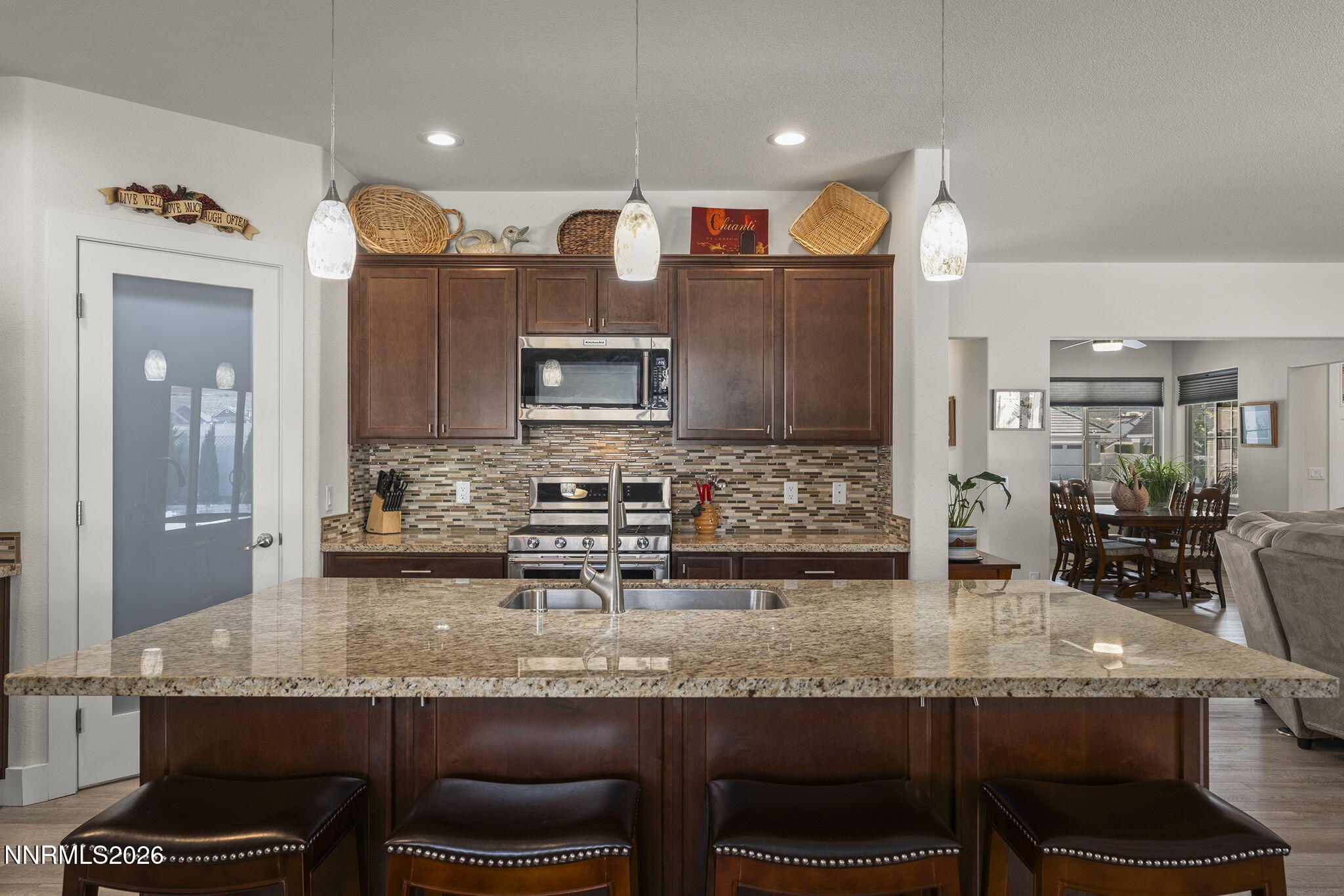 404 Chianti Way Dayton, NV 89403 - Photo 16 of 42 a kitchen with granite countertop a sink chairs and cabinets