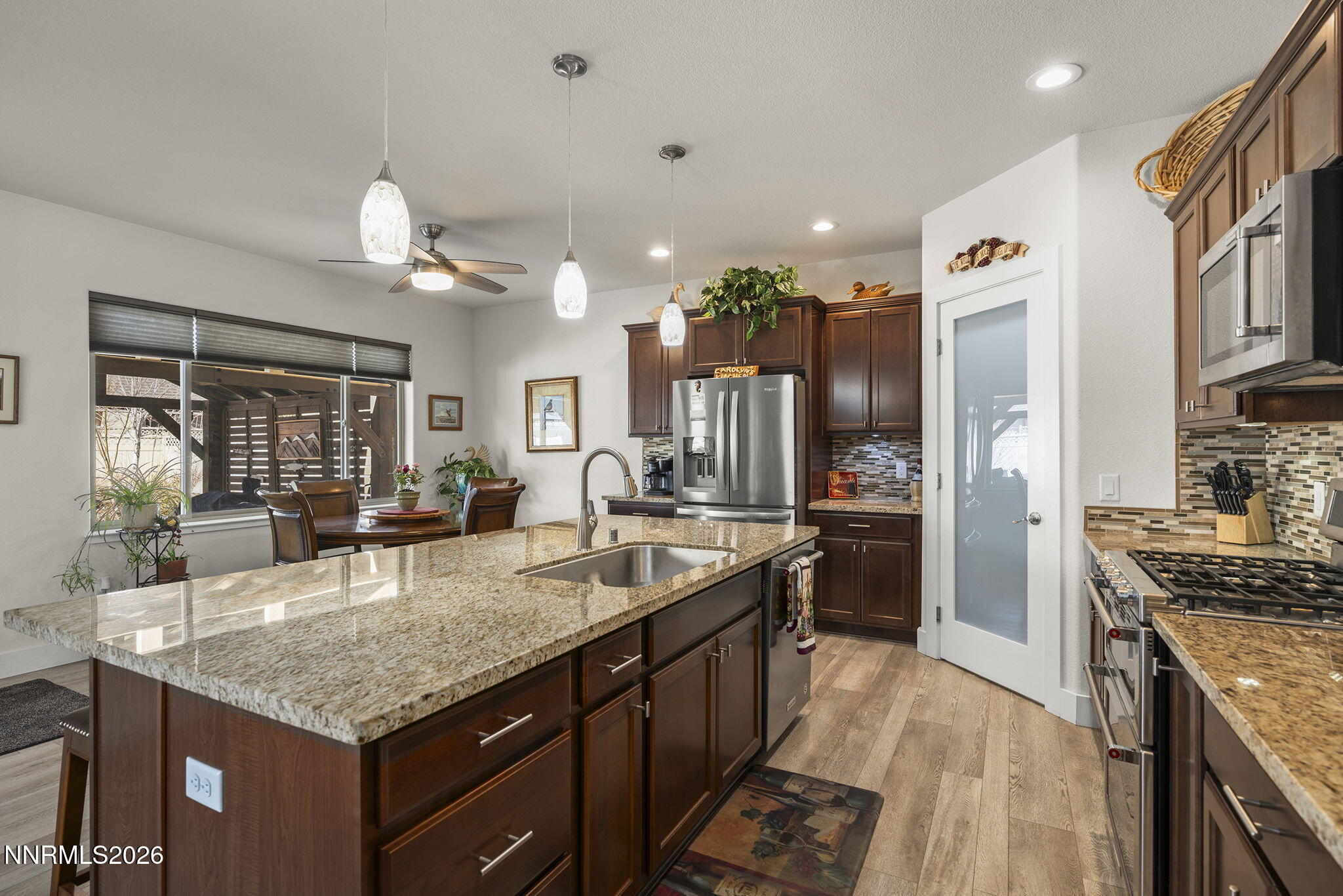 404 Chianti Way Dayton, NV 89403 - Photo 18 of 42 a kitchen with granite countertop kitchen island stainless steel appliances a sink stove and refrigerator