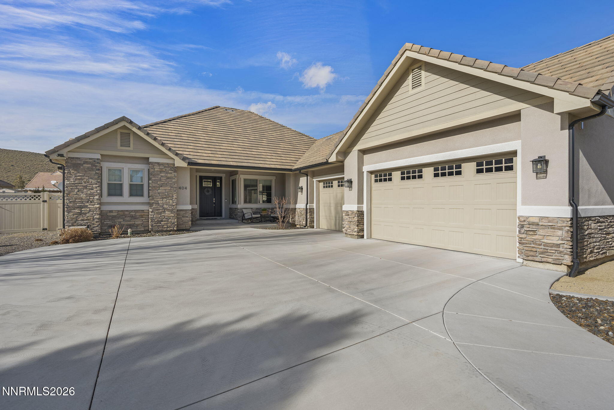 404 Chianti Way Dayton, NV 89403 - Photo 2 of 42 a view of a white house with a large space and a garage