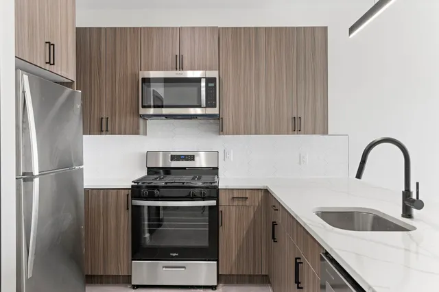 a kitchen with sink a microwave and refrigerator