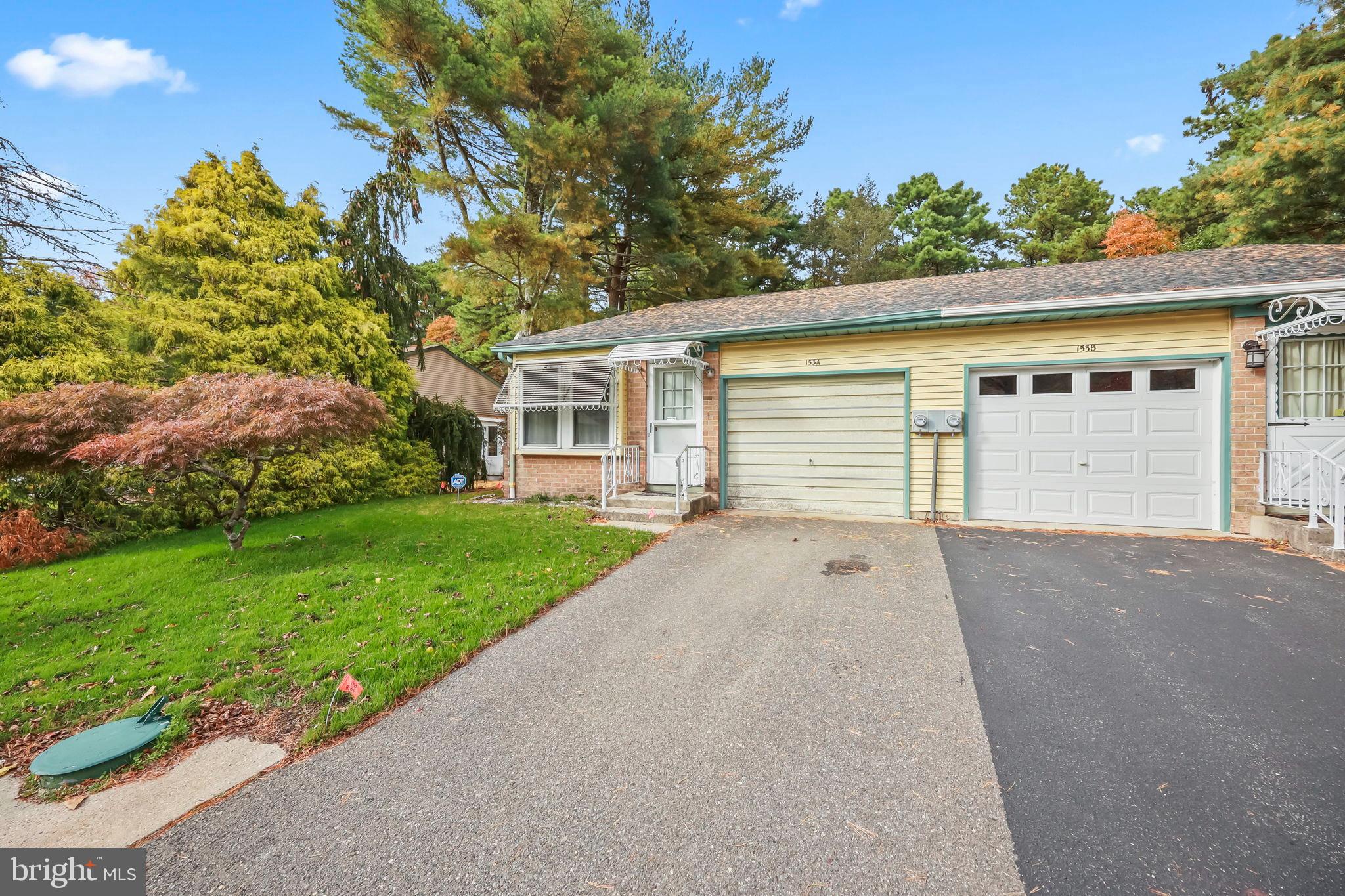 153B Sunset Road Whiting, NJ 08759 - Photo 19 of 19 front view of a house with a yard and a garage