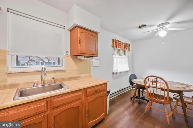 a kitchen with a sink cabinets and wooden floor