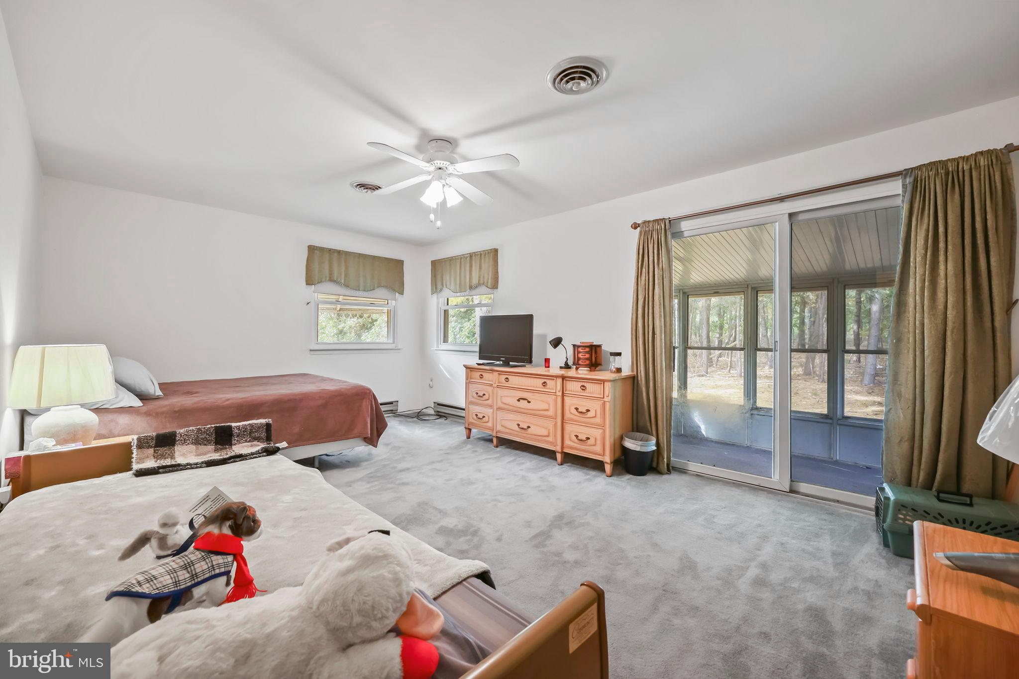 153B Sunset Road Whiting, NJ 08759 - Photo 7 of 19 a bedroom with furniture and a large window