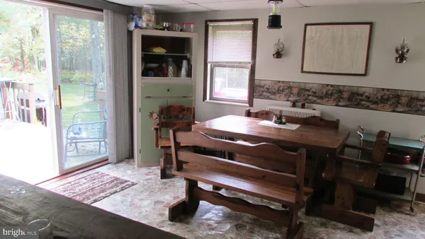 a bedroom with a bed and the dresser next to a window