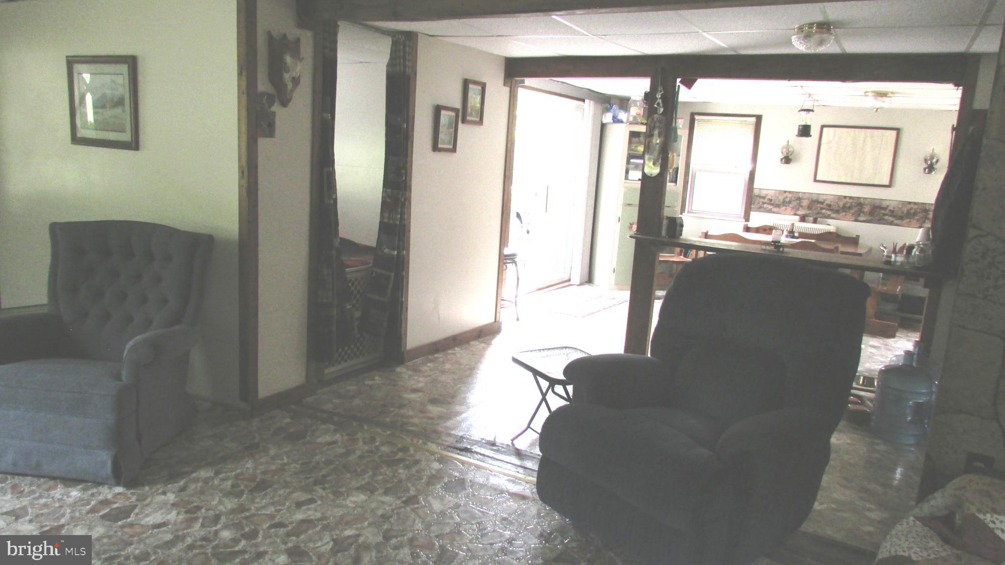 105 Big Run Road Howard, PA 16841 - Photo 15 of 37 a living room with furniture and a large mirror