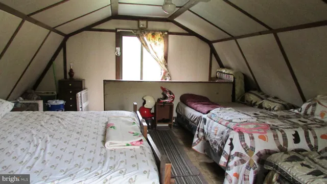 a bed sitting in a bedroom next to a window