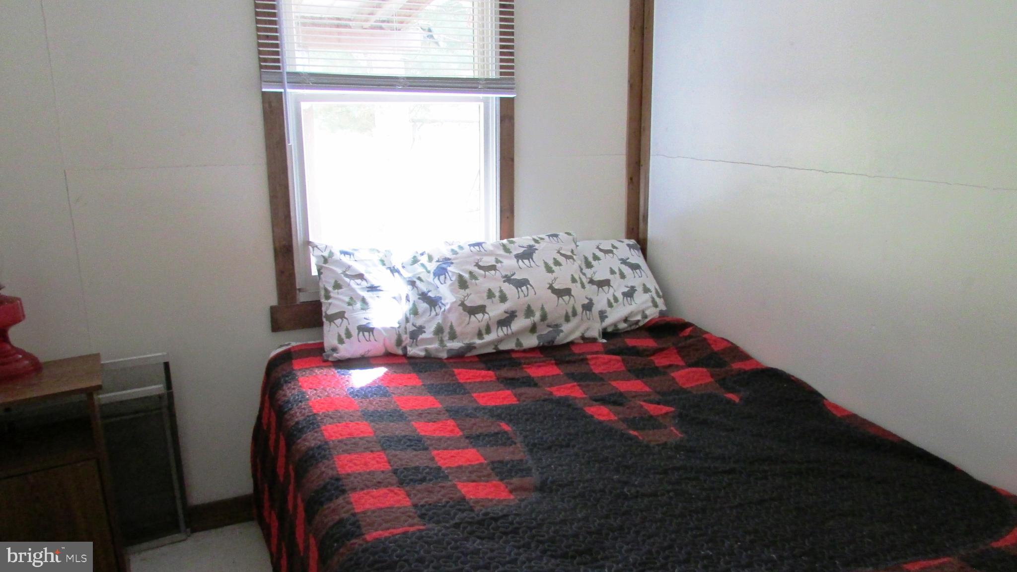 105 Big Run Road Howard, PA 16841 - Photo 19 of 37 a bedroom with a bed and window