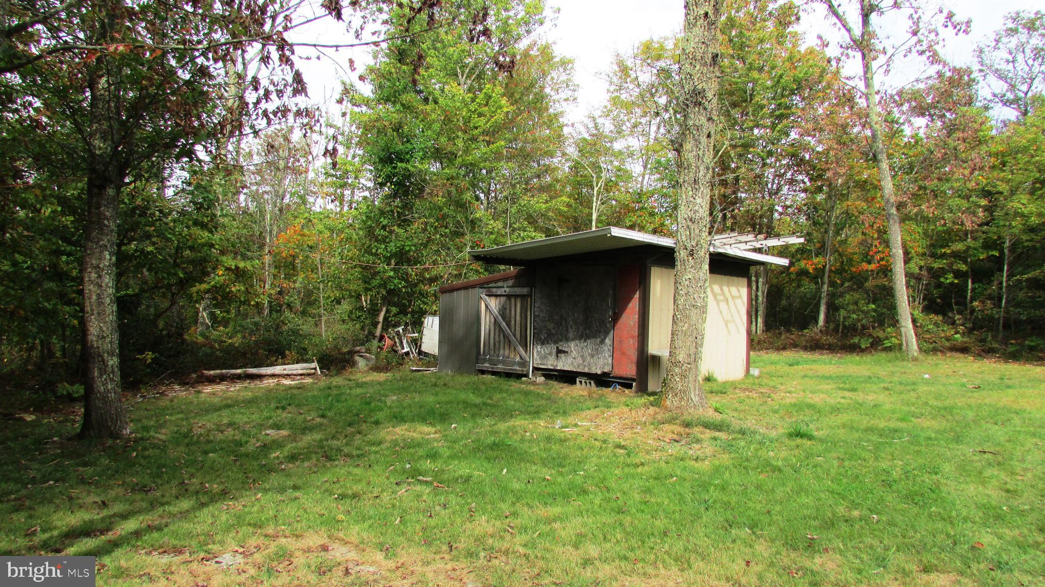 105 Big Run Road Howard, PA 16841 - Photo 21 of 37 a view of a barn in the middle of a yard