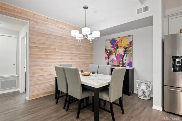 a view of a dining room with furniture wooden floor and a chandelier