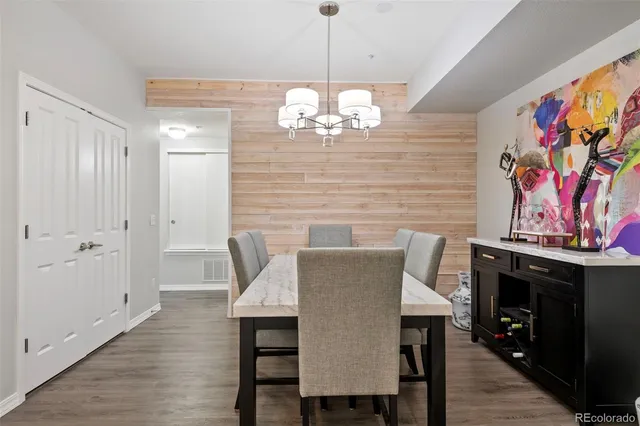 a view of a dining room with furniture wooden floor and a chandelier