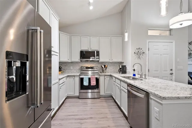 a kitchen with a sink stove and refrigerator