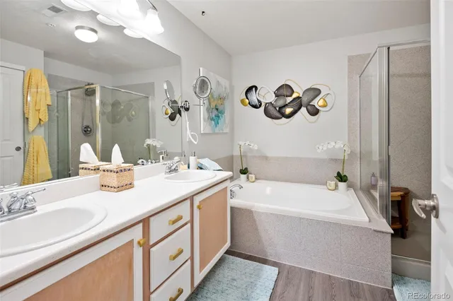 a bathroom with a sink a bathtub and a mirror