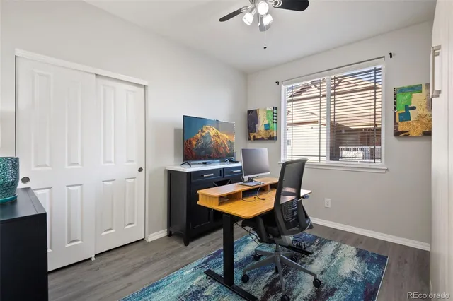 a workspace with wooden floor and a window