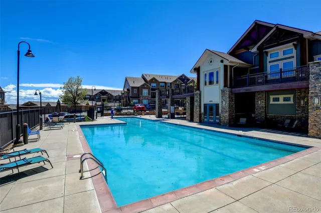 a swimming pool with outdoor seating and yard
