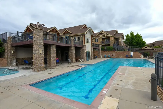 a view of a house with a small yard and potted plants