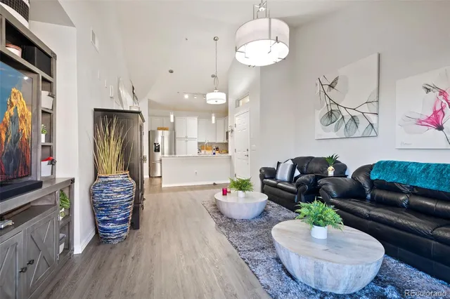 a living room with furniture and a chandelier