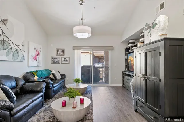 a living room with furniture and a wooden floor