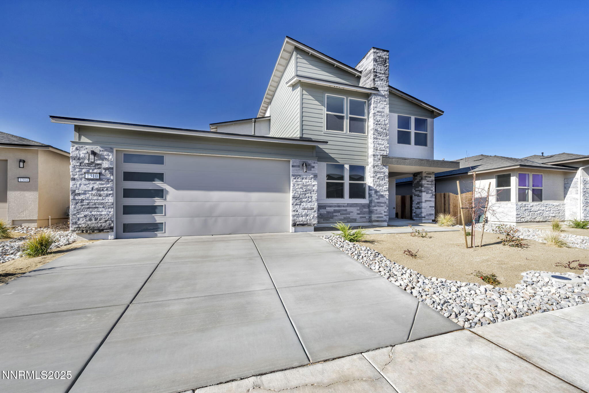 1310 Nebula Road, Unit HOMESITE 90 Carson City, NV 89705 - Photo 2 of 17 a front view of a house with a yard and garage
