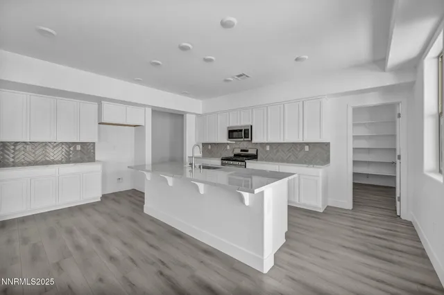 a kitchen with stainless steel appliances a refrigerator sink and cabinets