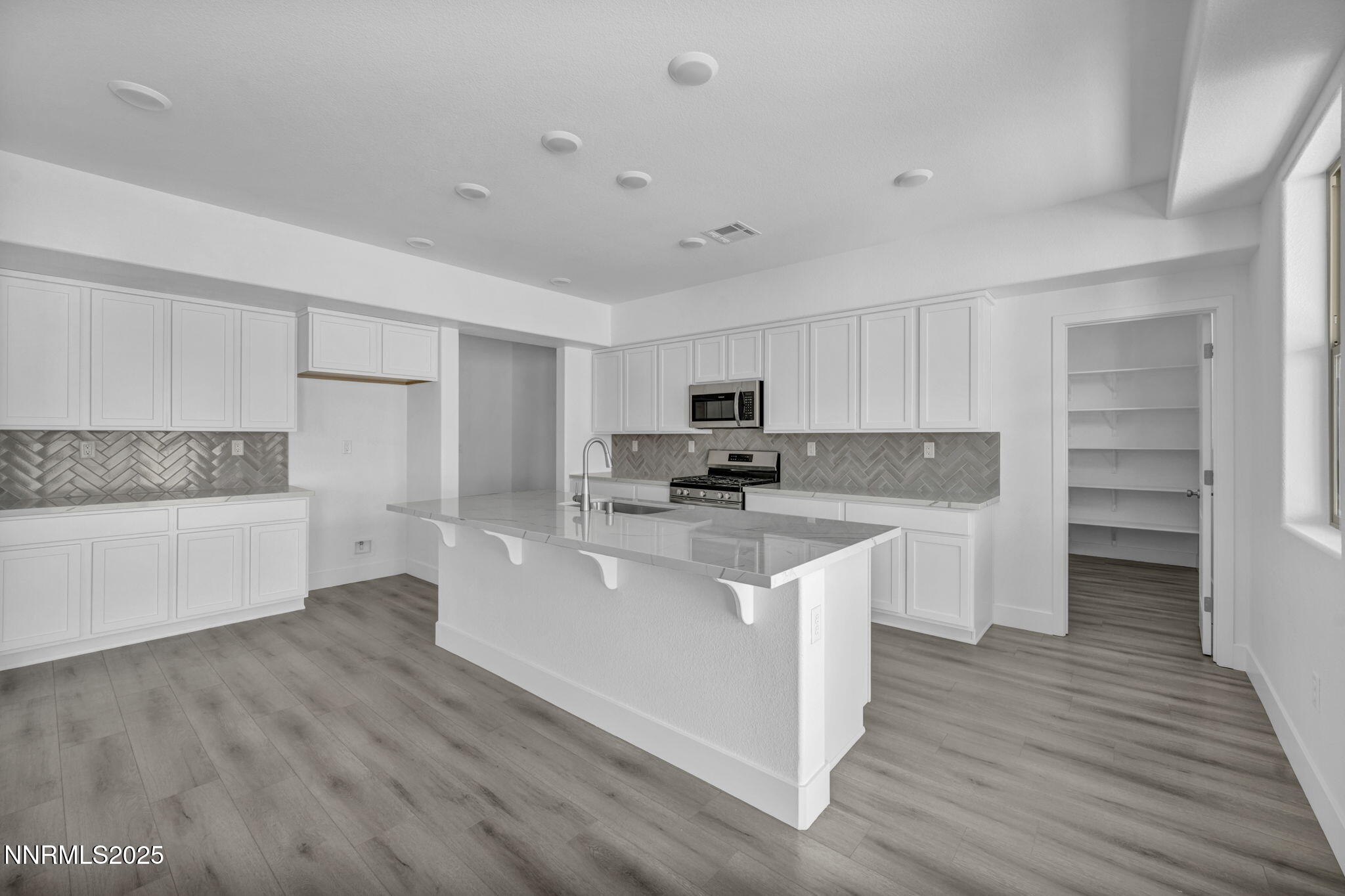 1310 Nebula Road, Unit HOMESITE 90 Carson City, NV 89705 - Photo 4 of 17 a kitchen with stainless steel appliances a refrigerator sink and cabinets