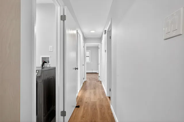 a view of a hallway with a wooden floor