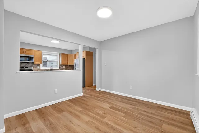 a view of a kitchen with an empty space and a window