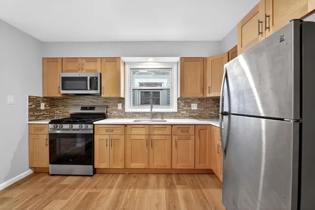 a kitchen with a refrigerator stove and microwave