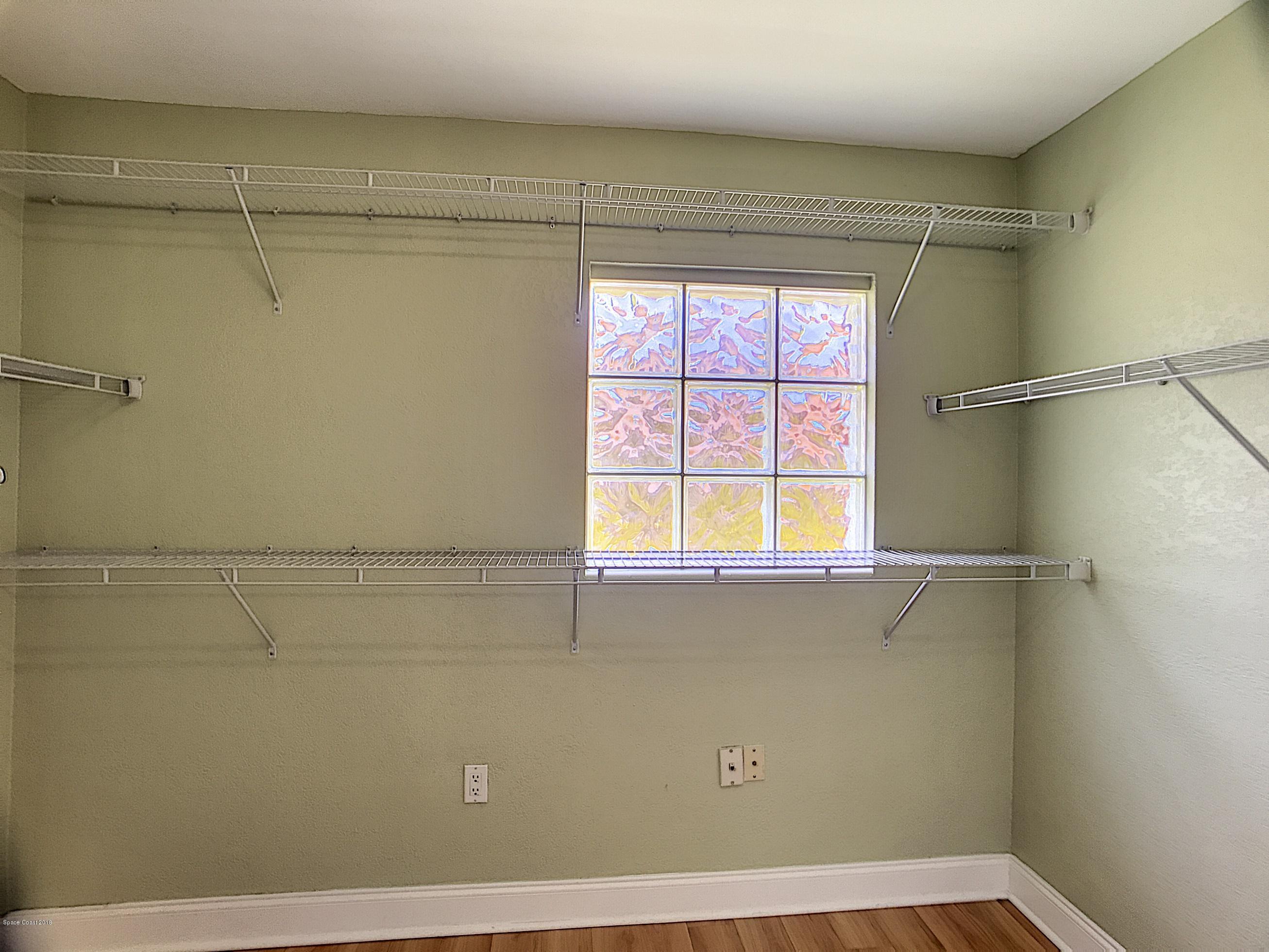 327 3rd Street Merritt Island, FL 32953 - Photo 19 of 26 a view of a closet in a room