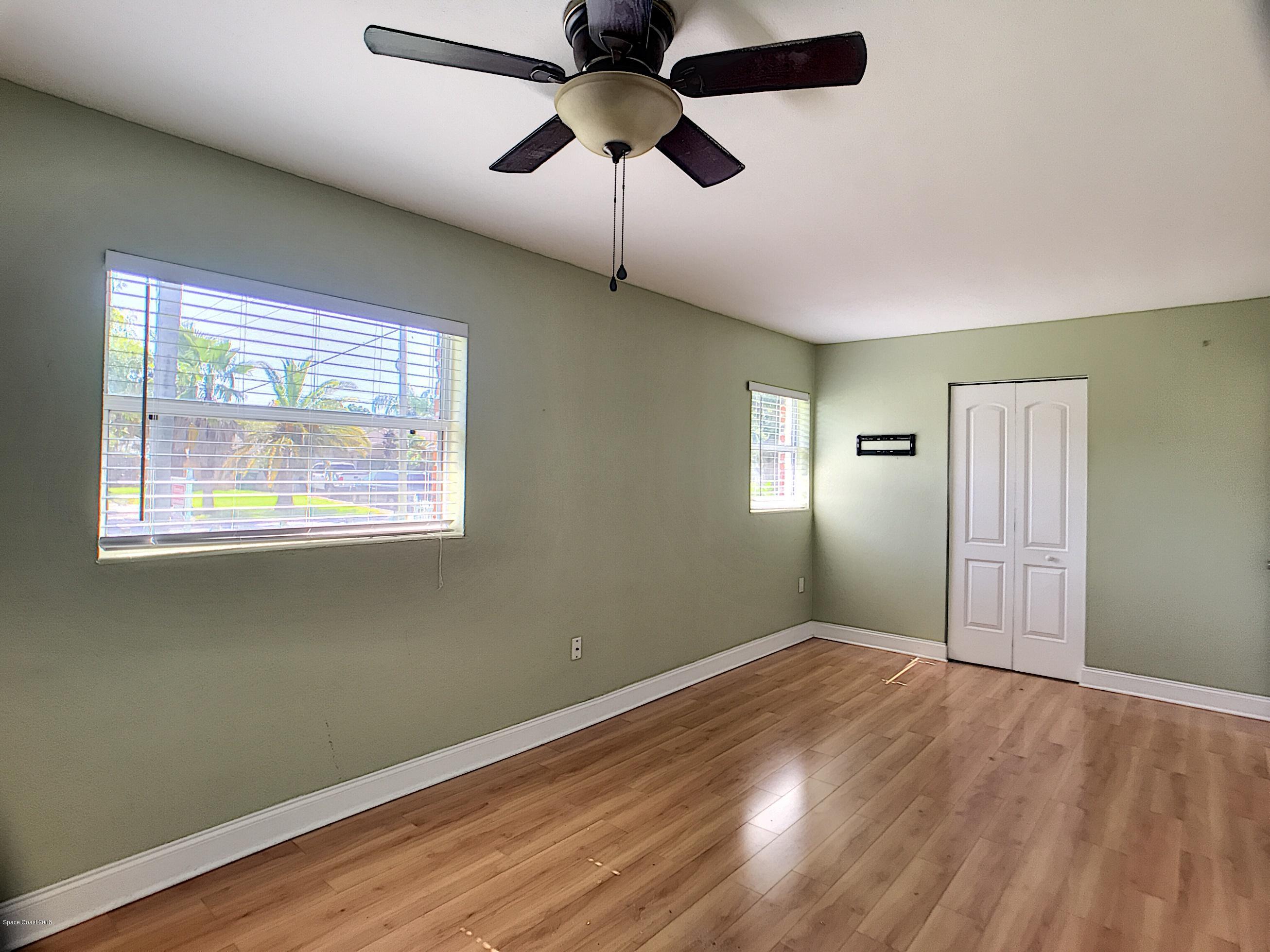 327 3rd Street Merritt Island, FL 32953 - Photo 21 of 26 a view of empty room with wooden floor and fan