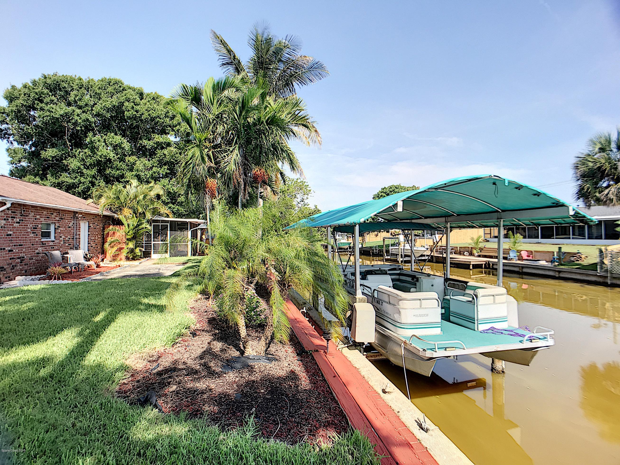 327 3rd Street Merritt Island, FL 32953 - Photo 25 of 26 a swimming pool with outdoor seating and yard