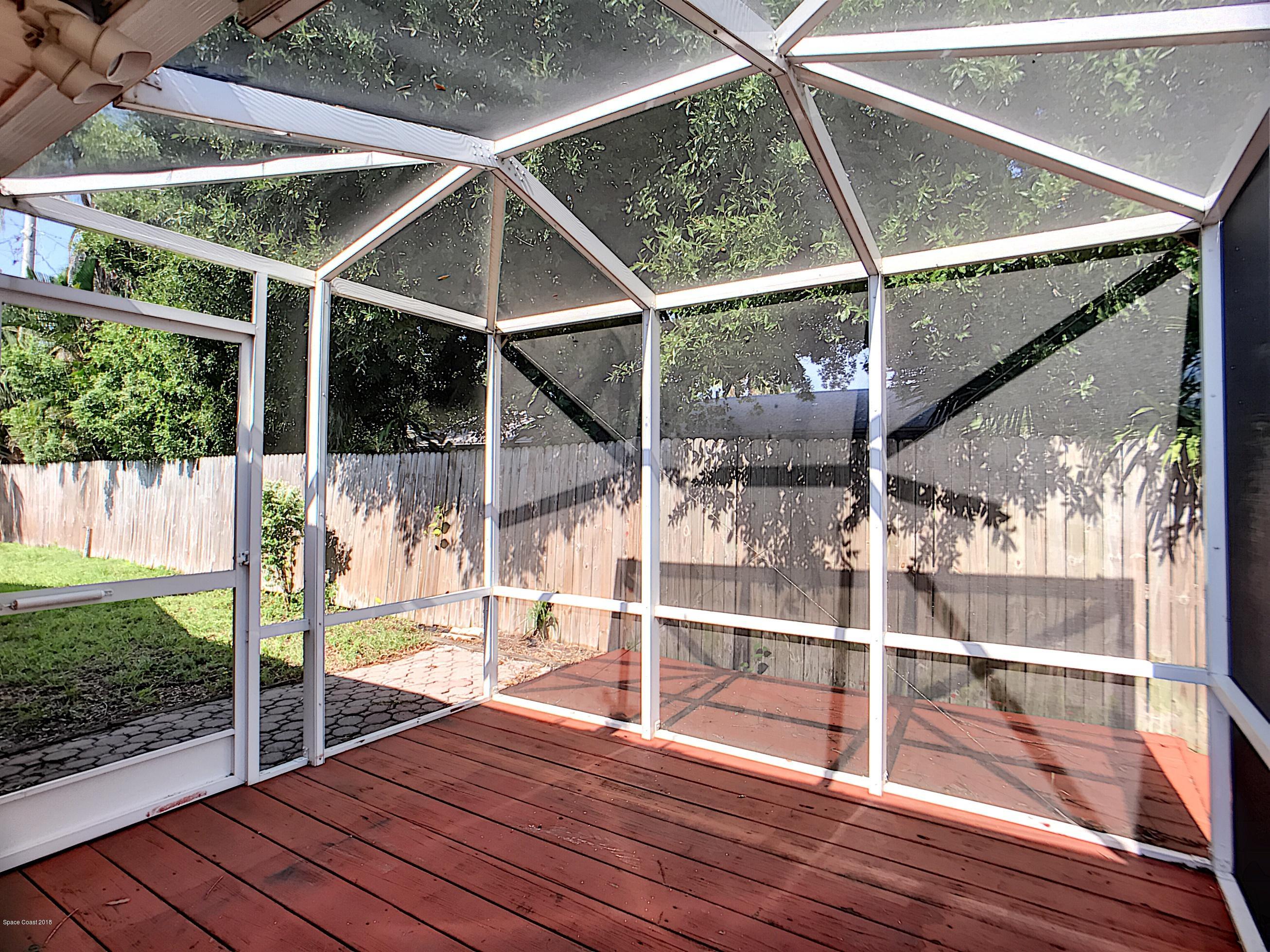 327 3rd Street Merritt Island, FL 32953 - Photo 9 of 26 a view of outdoor space with wooden floor and window