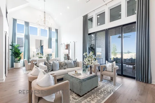 a living room with furniture wooden floor and a chandelier