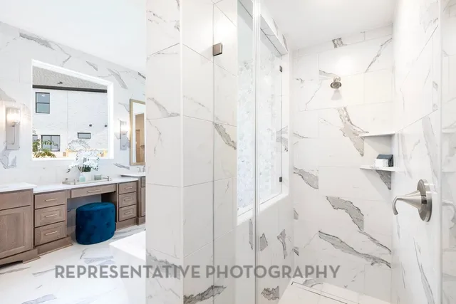 a bathroom with a tub sink shower and mirror