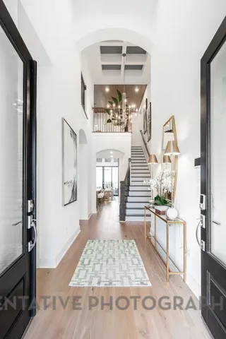 a view of entryway and hall with wooden floor