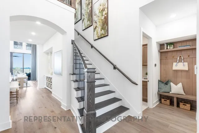a view of entryway and hall with wooden floor