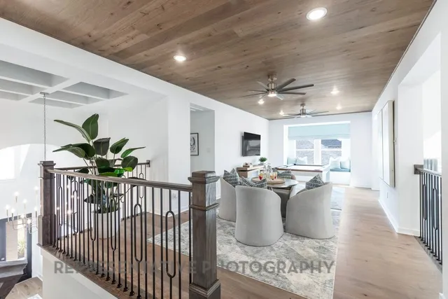 a view of a dining hall with a dining table chairs and couches