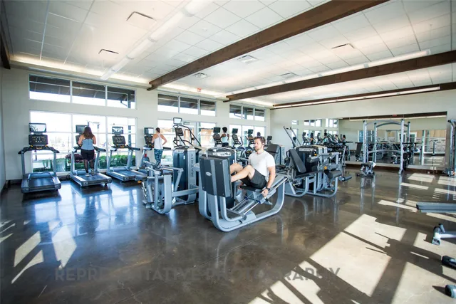 a view of a room with lots of tables and chairs