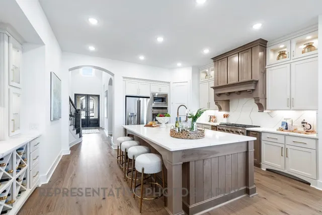 a kitchen with sink cabinets and wooden floor