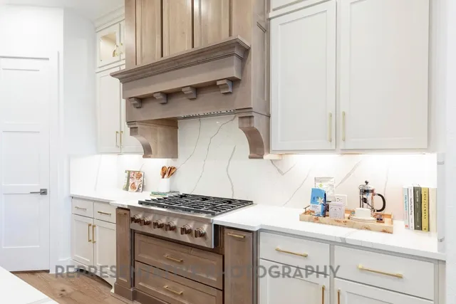 a kitchen with stainless steel appliances granite countertop a stove and a refrigerator