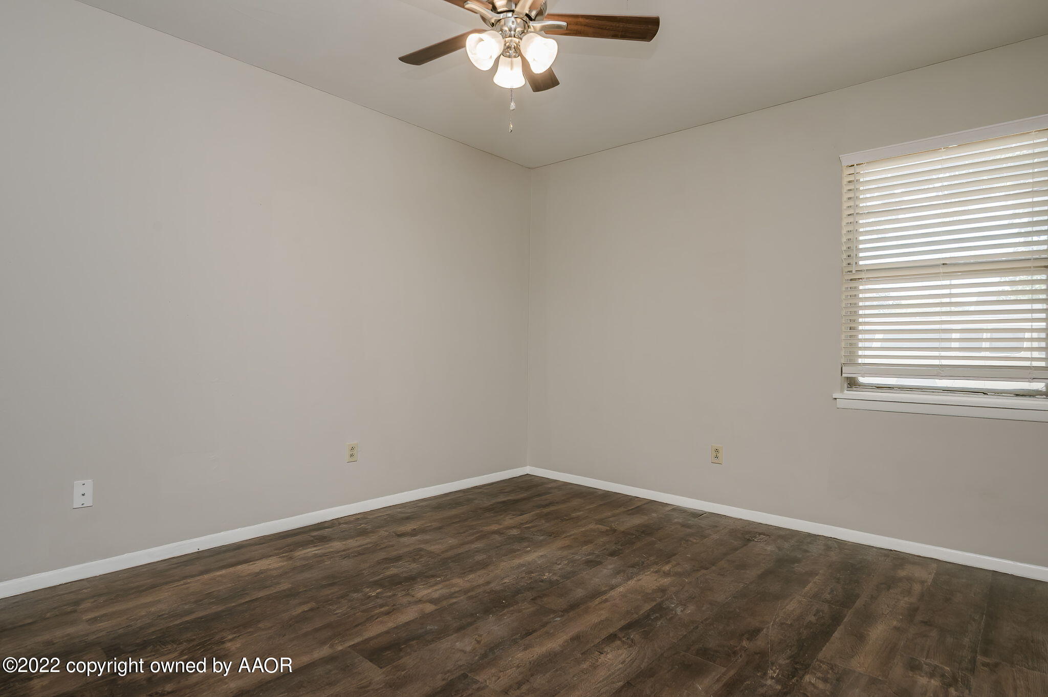 3405 Thurman Street Amarillo, TX 79109 - Photo 16 of 19 wooden floor in an empty room with a window