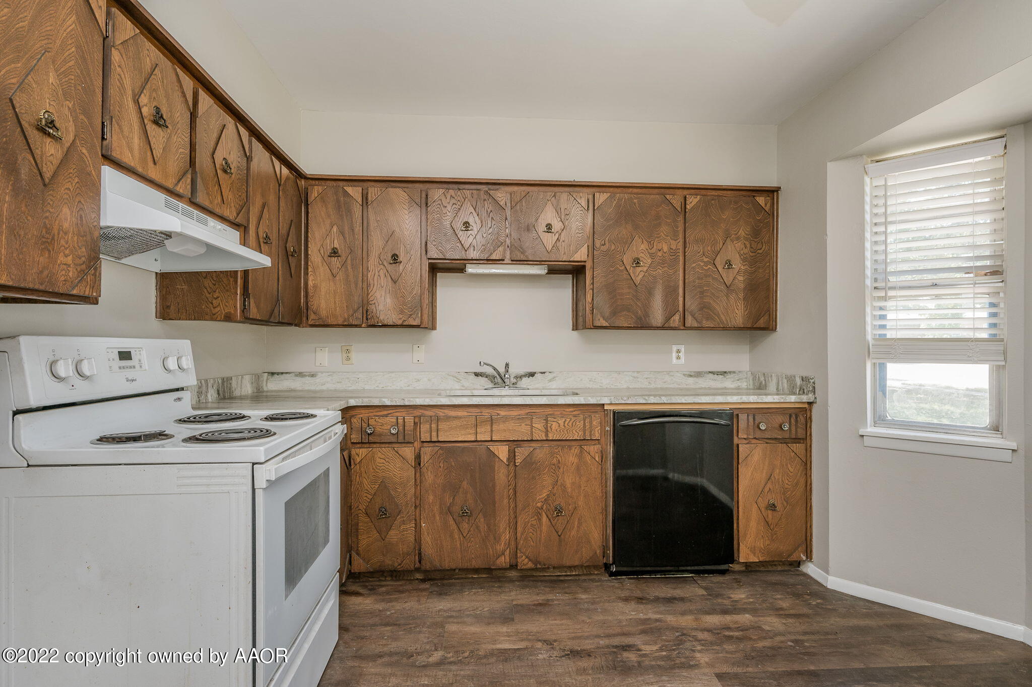 3405 Thurman Street Amarillo, TX 79109 - Photo 7 of 19 a kitchen with stainless steel appliances granite countertop a stove and a refrigerator