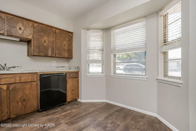 a kitchen with a stove a sink and a window