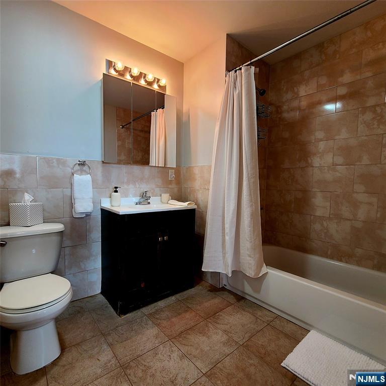 182 Anderson Avenue, Unit 3A Fairview, NJ 07022 - Photo 16 of 19 a bathroom with a sink a toilet and shower