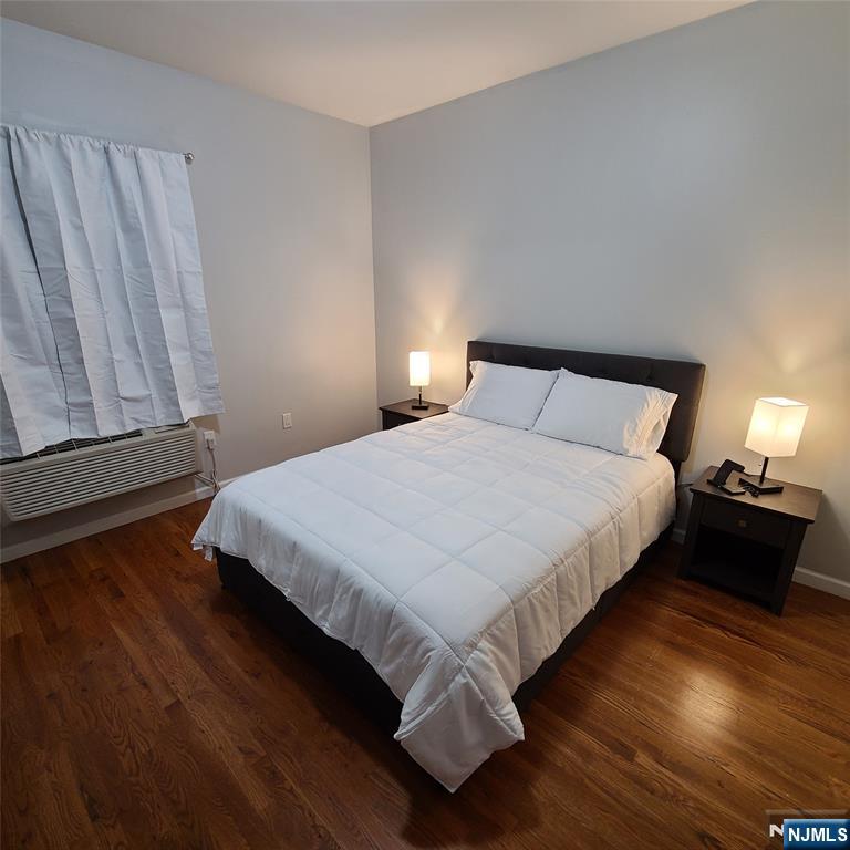 182 Anderson Avenue, Unit 3A Fairview, NJ 07022 - Photo 6 of 19 a bedroom with a bed and wooden floor